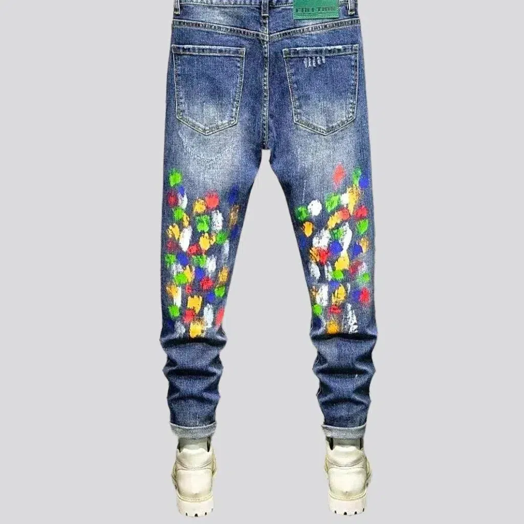 Multi-color stains sanded jeans